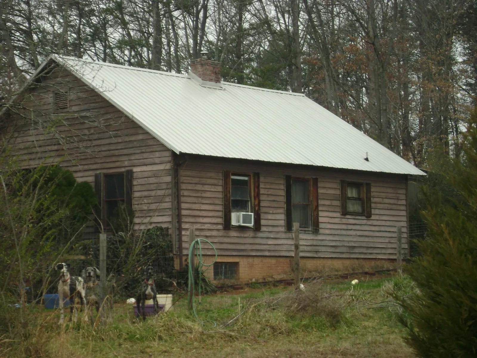 White metal roof on an old wood sided farmhouse, from a Metal Roof Installation job in Eldred